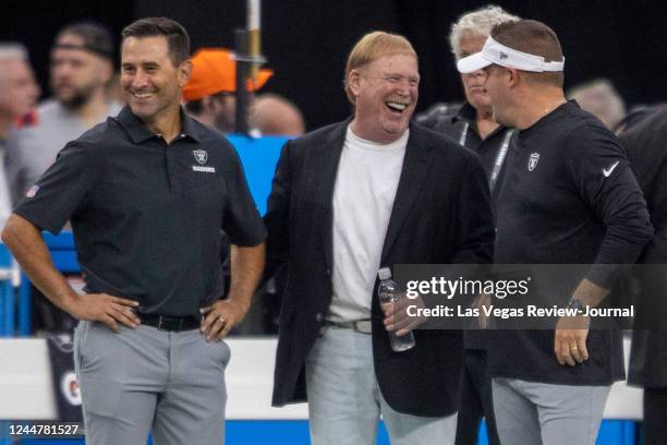 Las Vegas Raiders general manager Dave Ziegler, left, owner Mark Davis, center, and head coach Josh McDaniels share a moment before a game against...