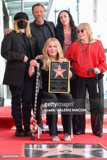 Actress Christina Applegate, joined by daughter Sadie Grace LeNoble, husband Martyn LeNoble, and US actress Nancy Priddy, poses for photos with...