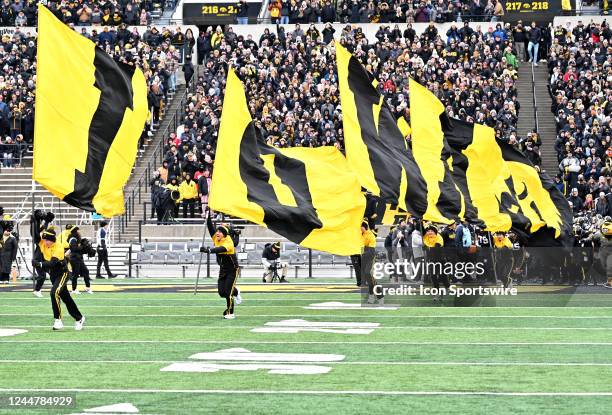 The Iowa cheerleaders lead the team onto the field before a college football game between the Wisconsin Badgers and the Iowa Hawkeyes, November 12 at...