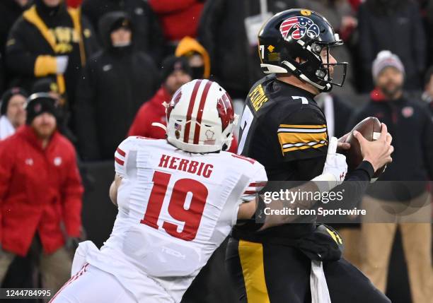 Wisconsin outside linebacker Nick Herbig sacks Iowa quarterback Spencer Petras during a college football game between the Wisconsin Badgers and the...