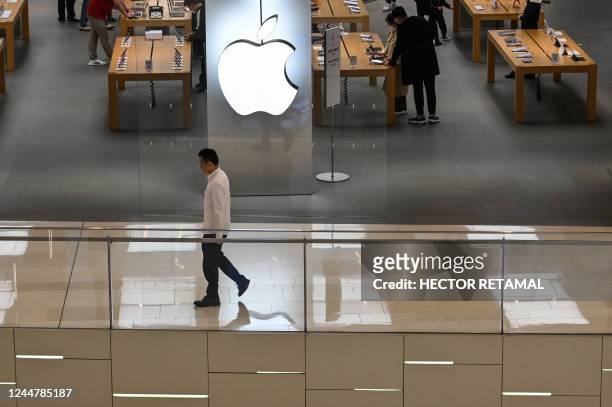 People are seen in an Apple store in a shopping mall in Shanghai on November 14, 2022.