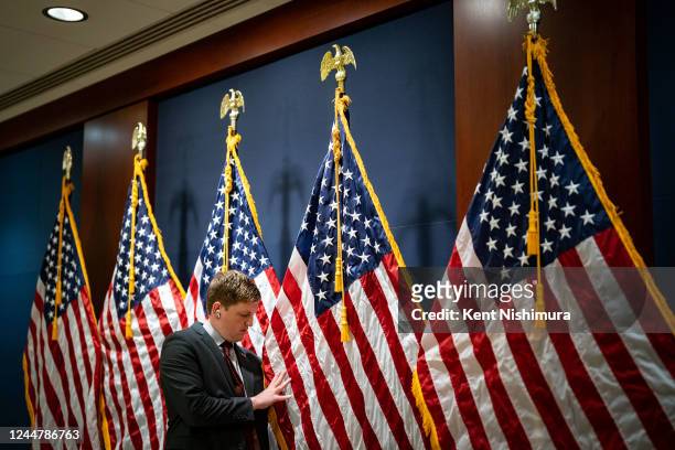 Staffer aligns US Flags at a television stake out area near where New House Member Orientation was being held on Capitol Hill on Monday, Nov. 14,...