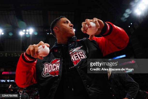 Baseball player Jeremy Pena of the Houston Astros throws balls into the crowd during the game between the Houston Rockets and the LA Clippers at the...