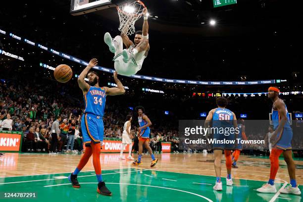 Jayson Tatum of the Boston Celtics shouts out after dunking over Kenrich Williams of the Oklahoma City Thunder during the second half at TD Garden on...