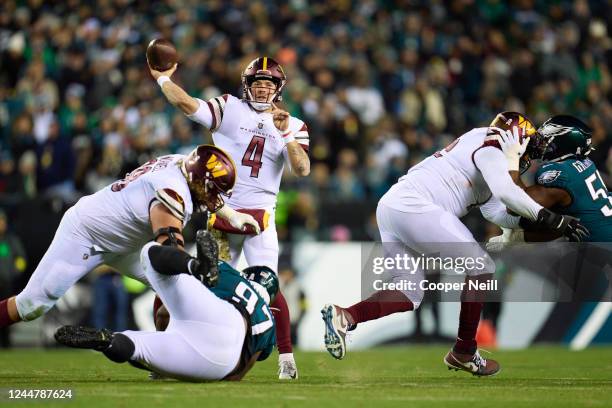 Taylor Heinicke of the Washington Commanders drops back to pass against the Philadelphia Eagles during the first half at Lincoln Financial Field on...
