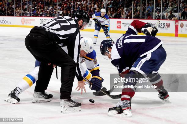 Ryan O'Reilly of the St. Louis Blues faces off against Andrew Cogliano of the Colorado Avalanche at Ball Arena on November 14, 2022 in Denver,...