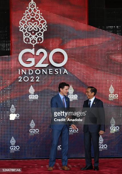 Canadian Prime Minister Justin Trudeau is welcomed by Indonesia's President Joko Widodo upon arrival for the G20 leaders' summit in Nusa Dua, on the...