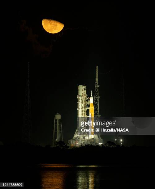 In this handout provided by the U.S. National Aeronautics and Space Administration , the moon is shown rising above the Space Launch System rocket...