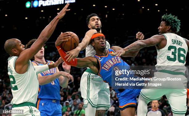 November 14: Al Horford, Jayson Tatum and Marcus Smart of the Boston Celtics gang up on Shai Gilgeous-Alexander of the Oklahoma City Thunder during...