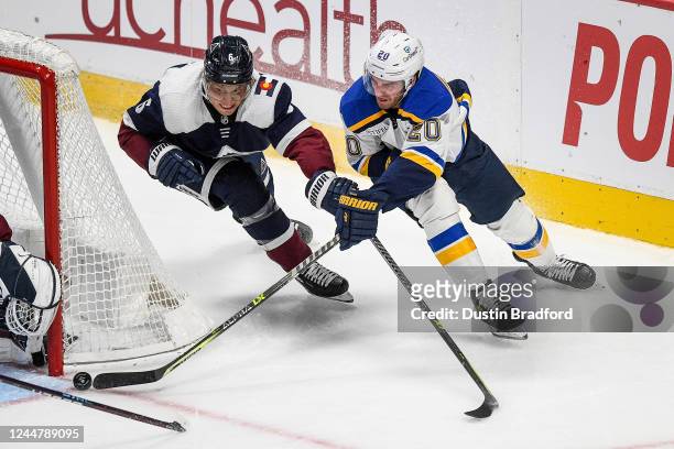 Brandon Saad of the St. Louis Blues attempts a wrap-around shot against Erik Johnson of the Colorado Avalanche in the third period at Ball Arena on...