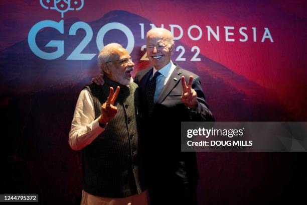 President Joe Biden gestures with India's Prime Minister Narendra Modi as the two leaders met in a hallway as Biden was going to a European...