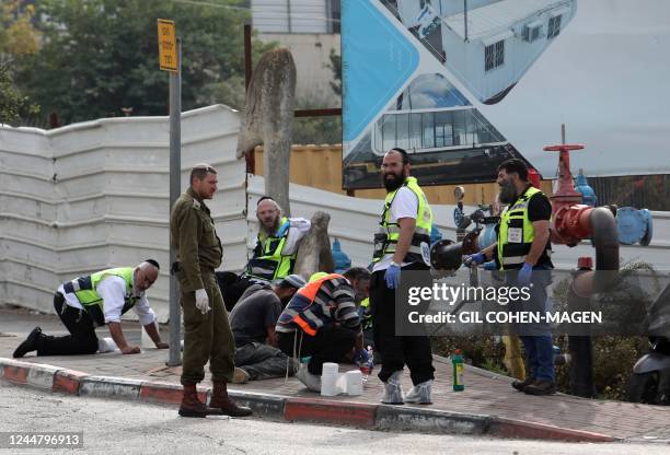 Graphic content / Israeli Zaka volunteers, an ultra-Orthodox Jewish emergency response team in Israel, work at the scene of an attack in the Ariel...