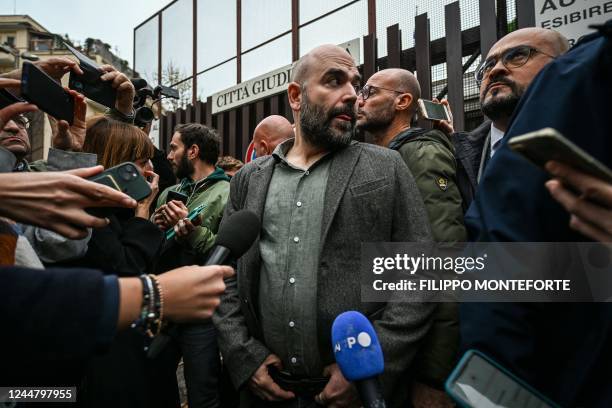 Italian writer Roberto Saviano is surrounded by the media on November 15, 2022 outside the City of Justice in Rome. - Italian journalist Roberto...