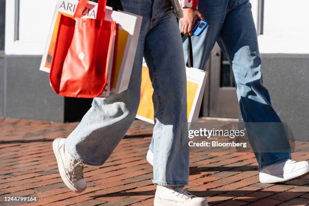 Pedestrians carry Lululemon and Aritzia shopping bags in the Georgetown neighborhood of Washington, DC, US, on Wednesday Nov. 9, 2022. The US Census...