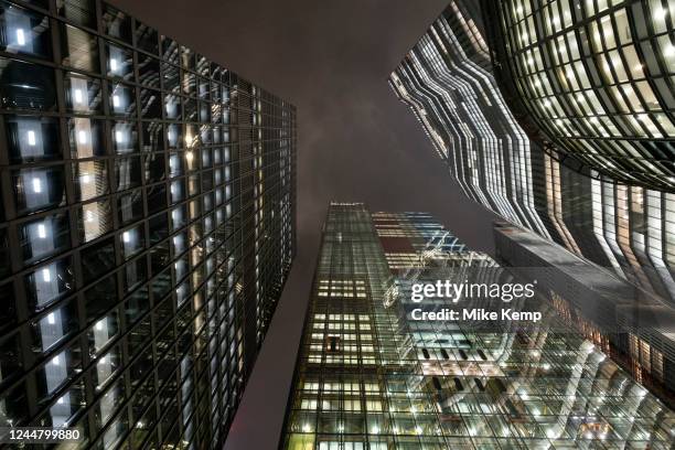 Looking up amidst the giant glass architectural towers including the St Helen's building on the left, Leadenhall building in the centre and 22...