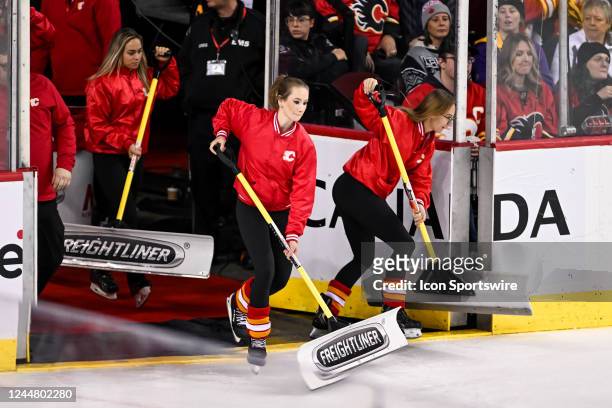 Calgary Flames ice girls clean the ice during the second period of an NHL game between the Calgary Flames and the Los Angeles Kings on November 14 at...