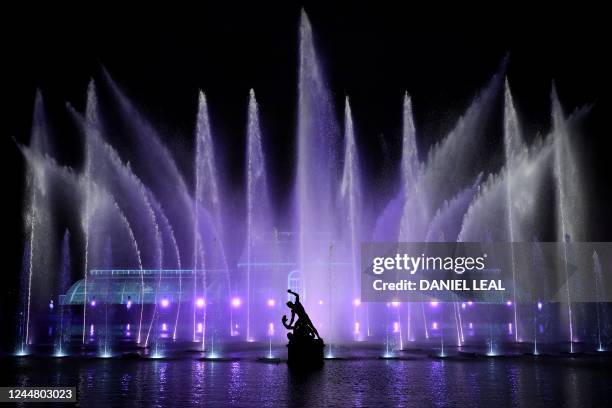 Lights illuminate the Palm House during a photocall to preview "Christmas at Kew" at Kew Gardens in southwest London on November 15, 2022. - -