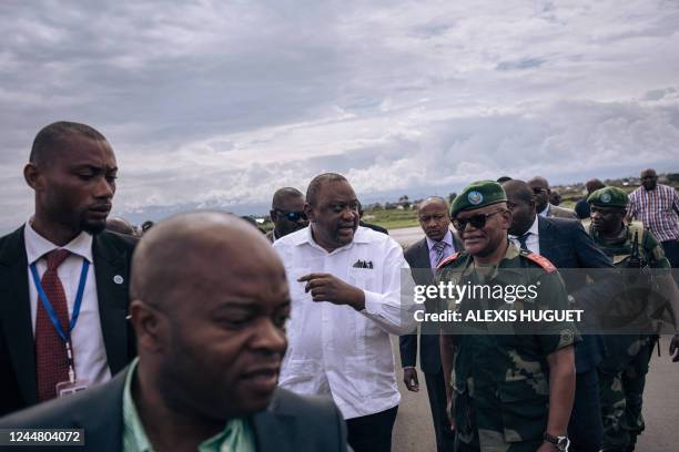 Former Kenyan president Uhuru Kenyatta is greeted by military authorities upon his arrival in Goma, eastern Democratic Republic of Congo, on November...