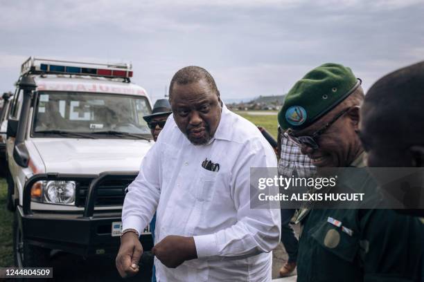 Former Kenyan president Uhuru Kenyatta talks with military authorities upon his arrival in Goma, eastern Democratic Republic of Congo, on November...