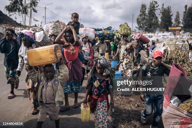 War-displaced people flee towards the city of Goma, eastern Republic of Congo, on November 15, 2022. - Thousands of displaced people began to flee...