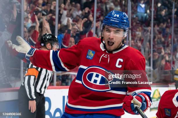 Nick Suzuki of the Montreal Canadiens celebrates after scoring a goal against the Pittsburgh Penguins during the third period in the NHL game at the...