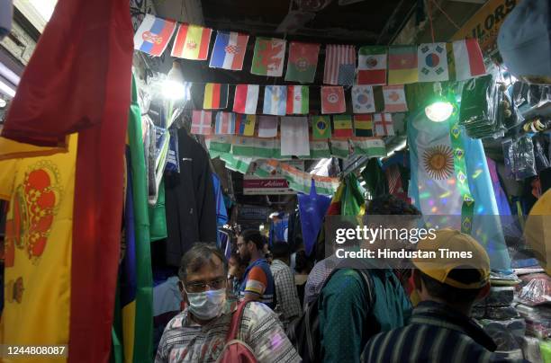 Jerseys of iconic football players like Messi, Neymar, Ronaldo and flags of Brazil, Argentina, and other nations on display for sale on at the...