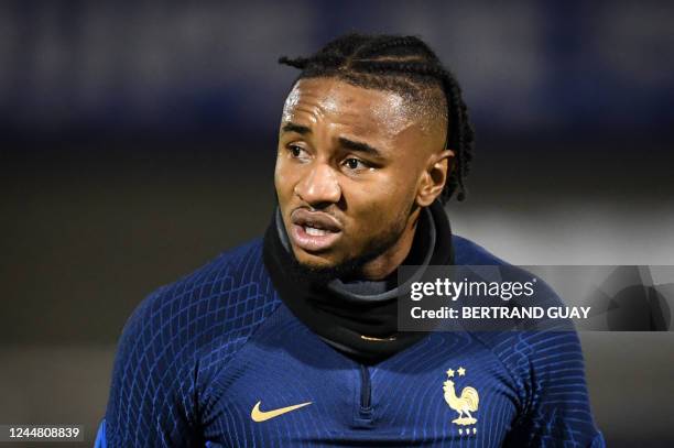 France's national football team forward Christopher Nkunku reacts after being injured during a training session at the team's training camp in...