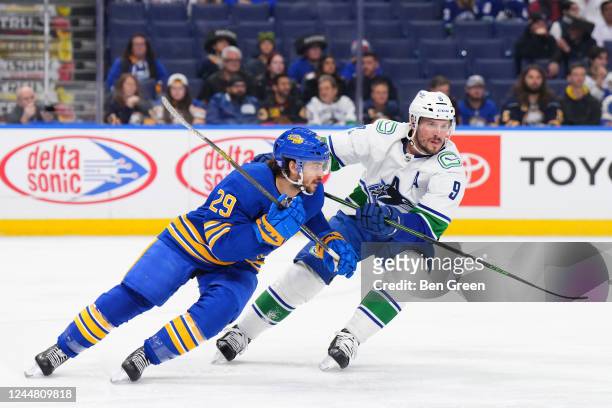Vinnie Hinostroza of the Buffalo Sabres skates against J.T. Miller of the Vancouver Canucks during an NHL game on November 15, 2022 at KeyBank Center...