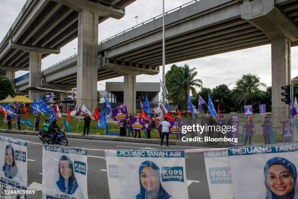 Supporters of Parti Bangsa Malaysia hold banners and flags along a road in Kuala Lumpur, Malaysia, on Tuesday, Nov. 15, 2022. As Malaysians head to...