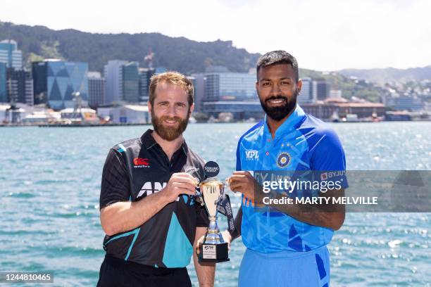 New Zealand captain Kane Williamson and India captain Hardik Pandya pose with the T20 trophy two days out from the first T20 match during a standup...