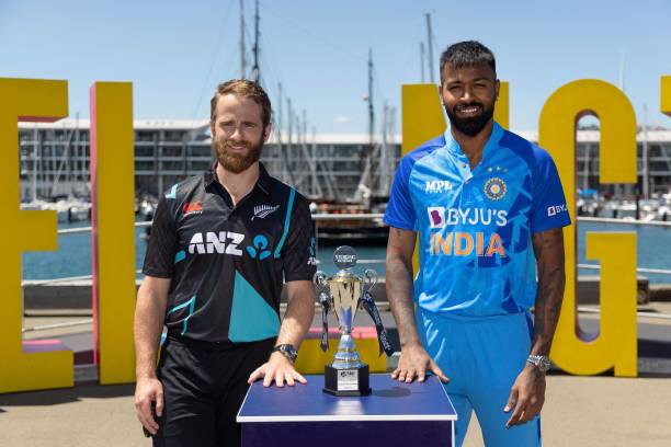 New Zealand captain Kane Williamson with India captain Hardik Pandya pose with the T20 trophy two days out from the first T20 match during a standup...