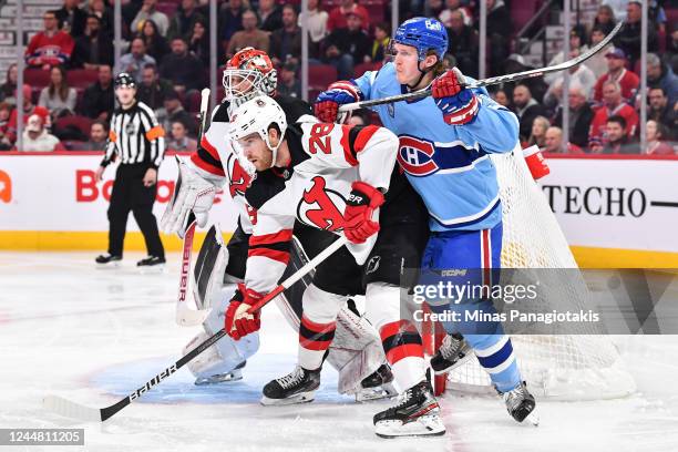 Christian Dvorak of the Montreal Canadiens and Damon Severson of the New Jersey Devils battle for position during the second period of the game at...