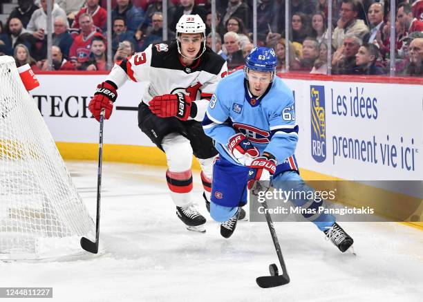 Evgenii Dadonov of the Montreal Canadiens skates the puck against Ryan Graves of the New Jersey Devils during the second period of the game at Centre...