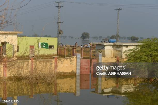 This picture taken on October 28 shows a deluged school in the flooded area of Chandan Mori, in Dadu district of Sindh province. - This summer,...