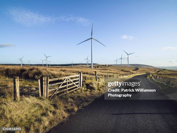 wind turbines on a wind farm in rural ulster, northern ireland. - ireland road stock pictures, royalty-free photos & images