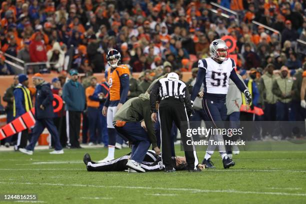 Umpire Jeff Rice lays on the ground during an NFL game between the Denver Broncos and the New England Patriots in Denver., Sunday, Nov 12, 2017.