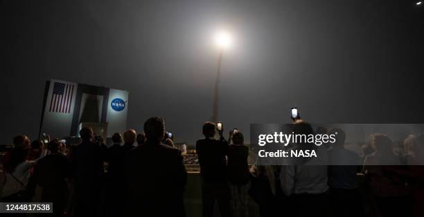 In this handout provided by the U.S. National Aeronautics and Space Administration , guests watch the launch of NASAs Space Launch System rocket...