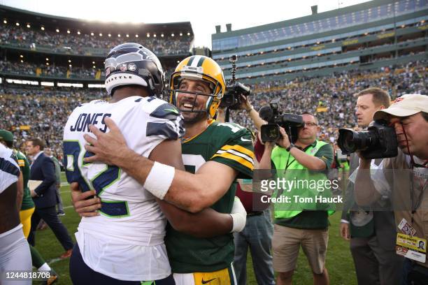 Seattle Seahawks defensive tackle Nazair Jones and Green Bay Packers quarterback Aaron Rodgers hug during an NFL game between the Green Bay Packers...