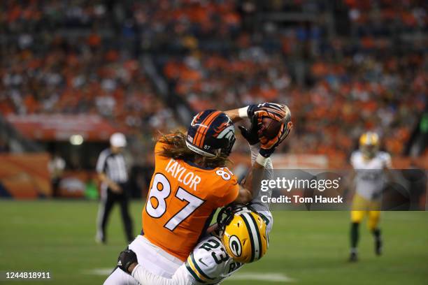 Denver Broncos wide receiver Jordan Taylor catches pass over Green Bay Packers cornerback Damarious Randall in action during an NFL preseason game...