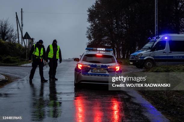 Police block a road on November 16, 2022 near the site where a missile strike killed two men in the eastern Poland village of Przewodow, near the...