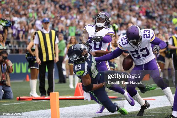 Seattle Seahawks wide receiver Doug Baldwin is hit at the goal line by Minnesota Vikings cornerback Terence Newman and fumbles the ball during an NFL...