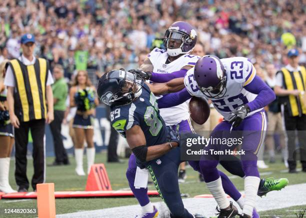 Seattle Seahawks wide receiver Doug Baldwin is hit at the goal line by Minnesota Vikings cornerback Terence Newman and fumbles the ball during an NFL...