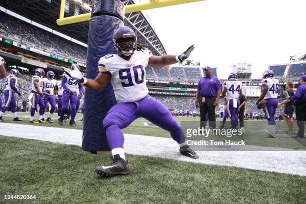 Minnesota Vikings defensive tackle Will Sutton warms up on the goal post during an NFL preseason game between the Seattle Seahawks and Minnesota...