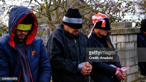 Eyes closed and hands tied people, arrested in Kherson for allegedly collaborating with the Russians, are seen before taken to Mykolaiv to be brought...