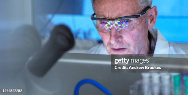 scientist using a 3d molecular structure on screen, researching potential covid-19 drug in the laboratory. medical and clinical trials. - corona virus computer graphic stock pictures, royalty-free photos & images