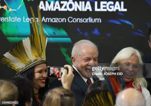 Brazilian president-elect Luiz Inacio Lula da Silva smiles next to singer Fafa de Belem during a discussion about the Amazon Forest at the COP27...