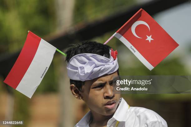 Balinese kid is seen with Turkish and Indonesian flags as they wait for head of state's vehicles passes to Tahura Mangrove Forest within G20 Leaders'...
