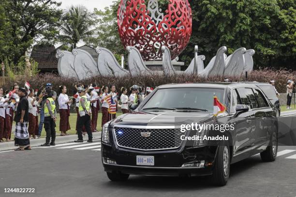 Balinese kids wave flags as US President vehicles passes to Tahura Mangrove Forest within G20 Leaders' Summit in Nusa Dua, Bali, Indonesia on...