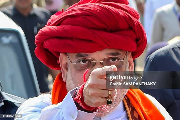 Indias Home Minister Amit Shah gestures during a political rally while accompanying Gujarats Chief Minister Bhupendrabhai Patel ahead of Gujarat's...