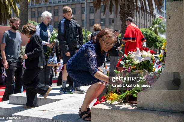 Woman lays a wreath at the annual Remembrance Day memorial service and wreath-laying parade at the Cenotaph War Memorial Statue in Heerengracht...